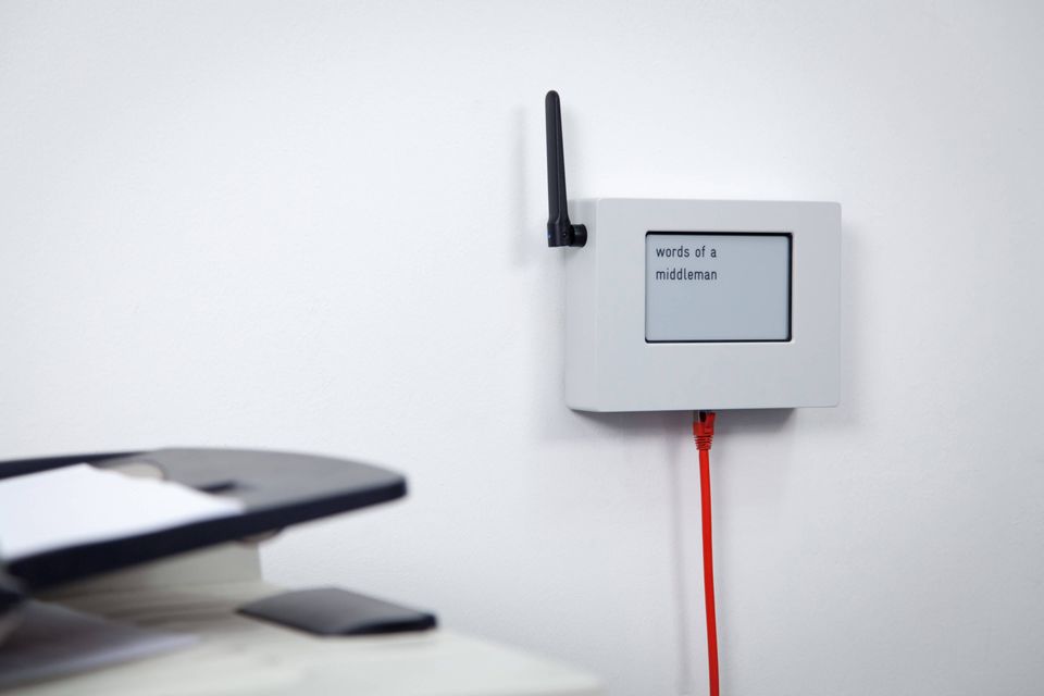 Router device with display, antenna and network cable in office environment
